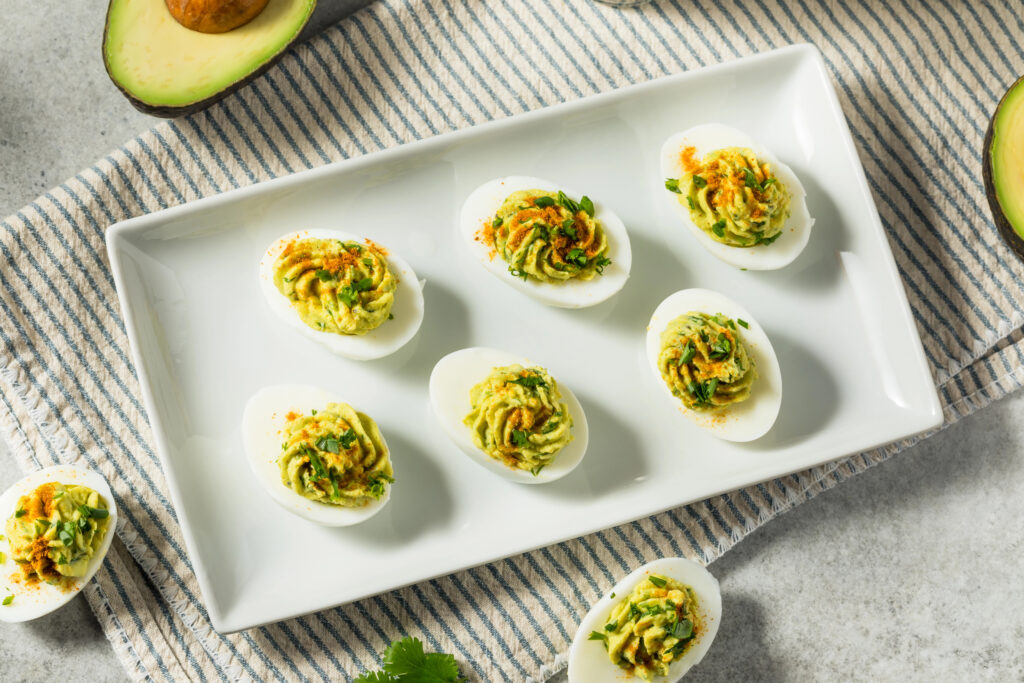 deviled eggs on a white platter