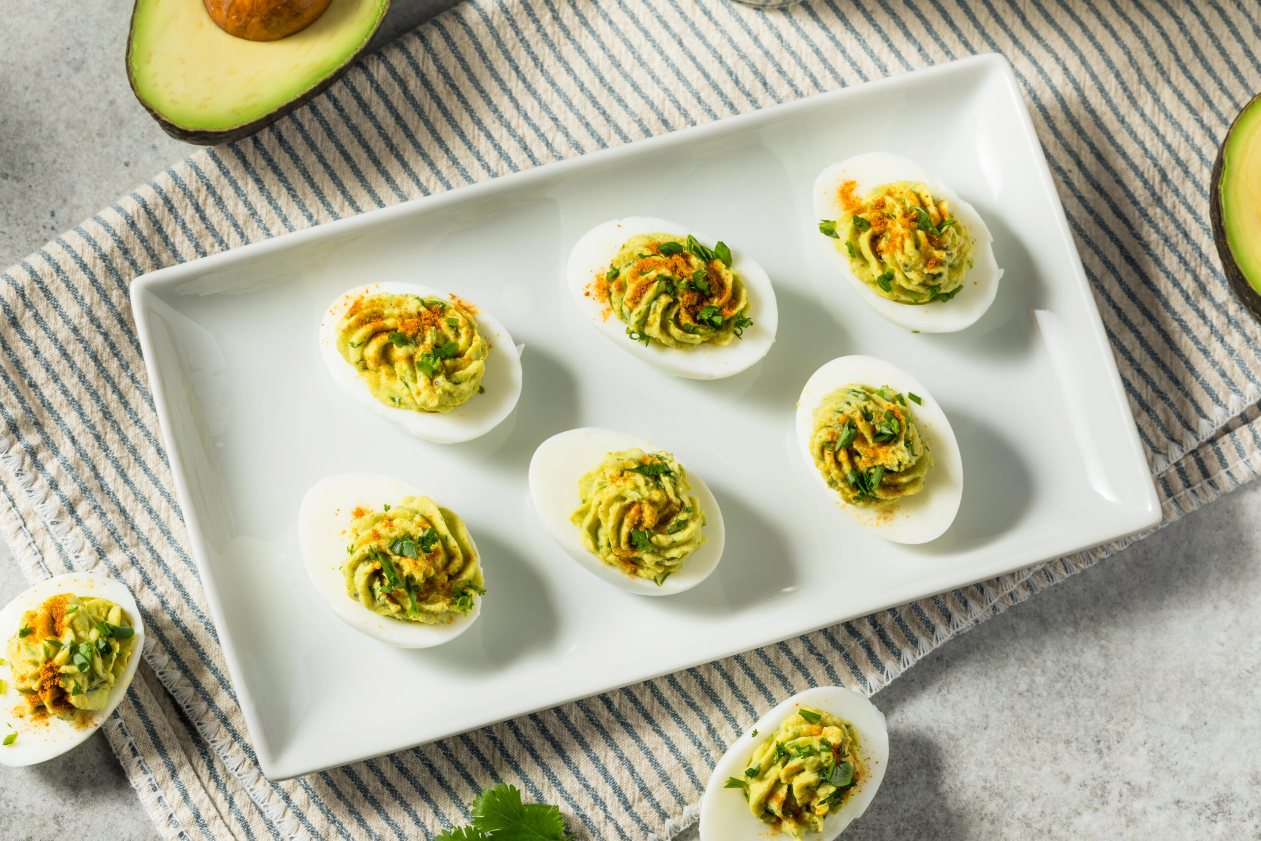 deviled eggs on a white platter
