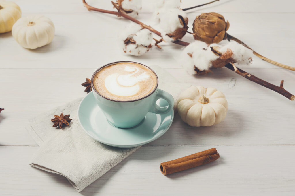 coffee in light blue mug with fall decor